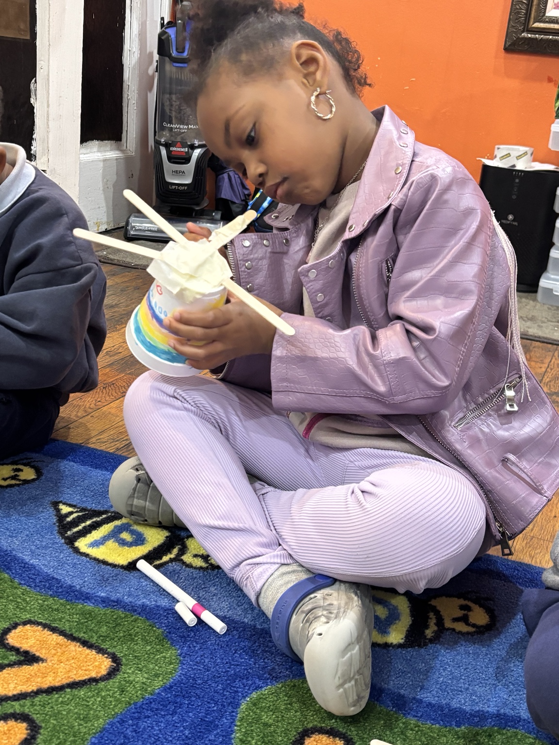 Child completing a colorful classroom activity