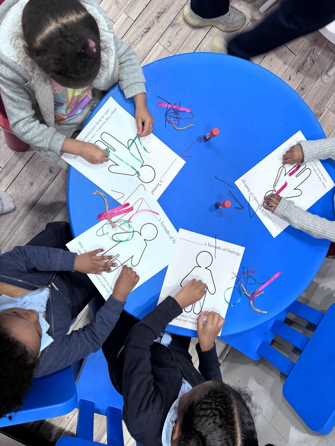Children completing a feelings activity together